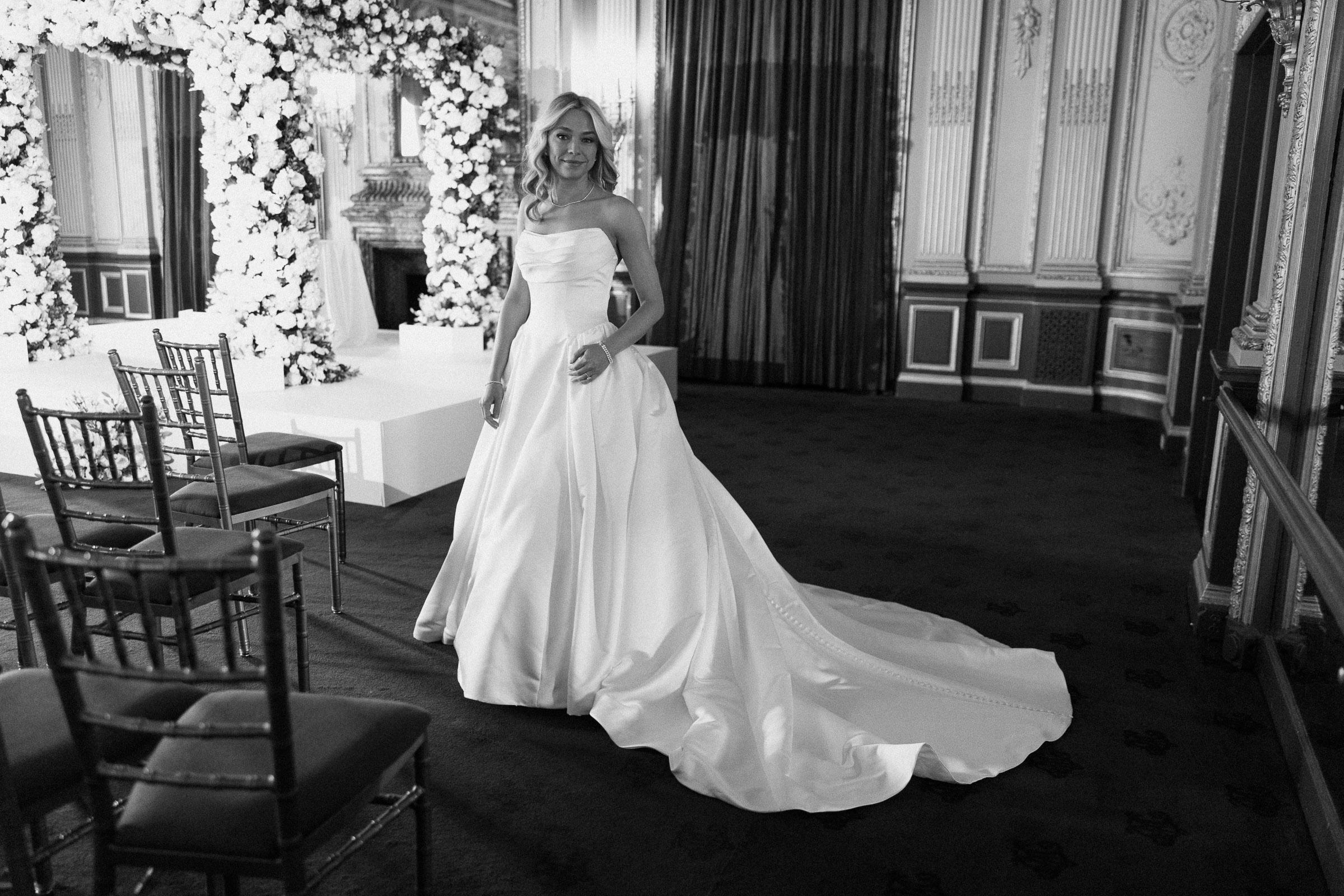 Black-and-white portrait of Colette walking through the ceremony room