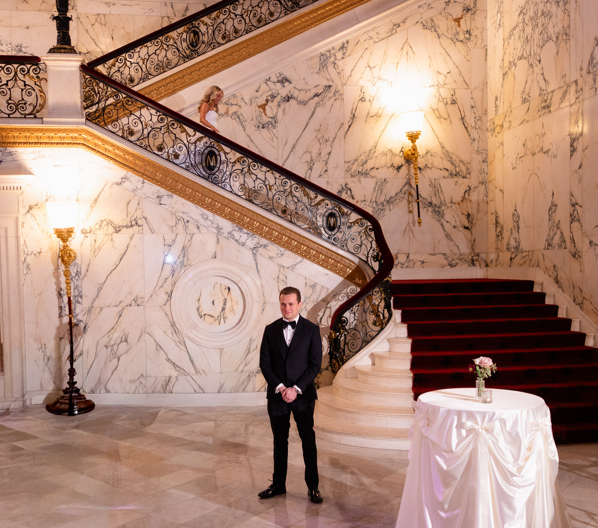 Cameron standing at the base of the Metropolitan Club marble staircase