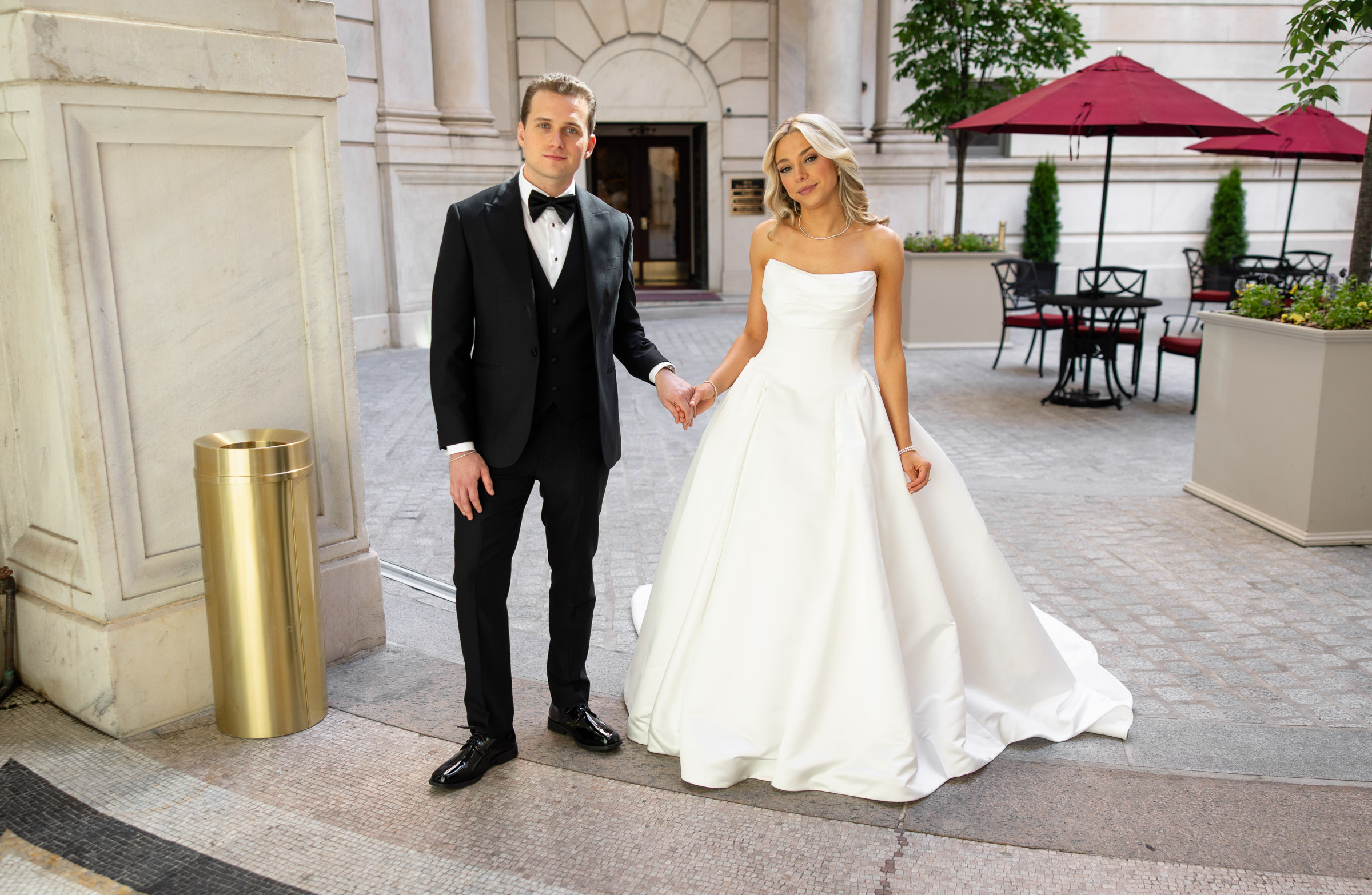 Colette and Cameron posing in the Metropolitan Club courtyard entrance