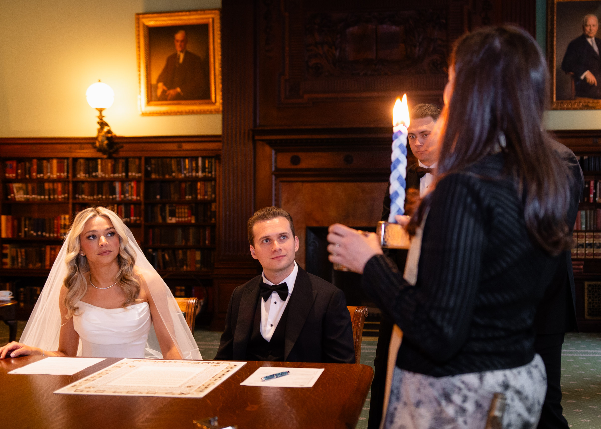 Colette and Cameron seated with family for their ketubah signing