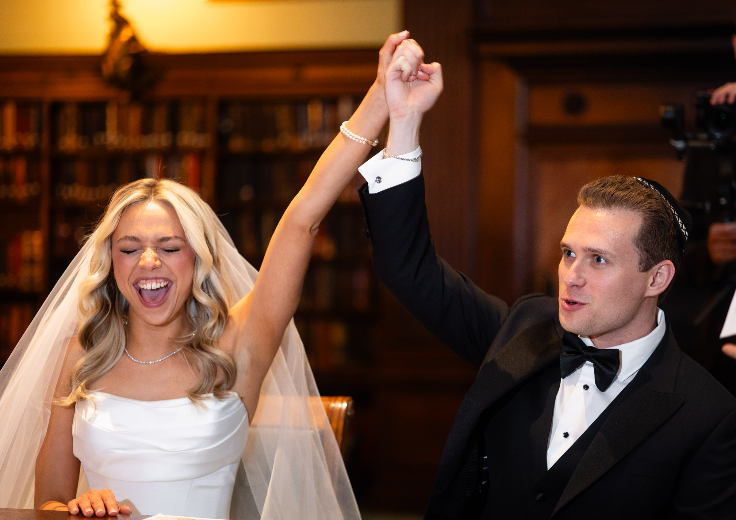 Colette and Cameron celebrating after signing the ketubah