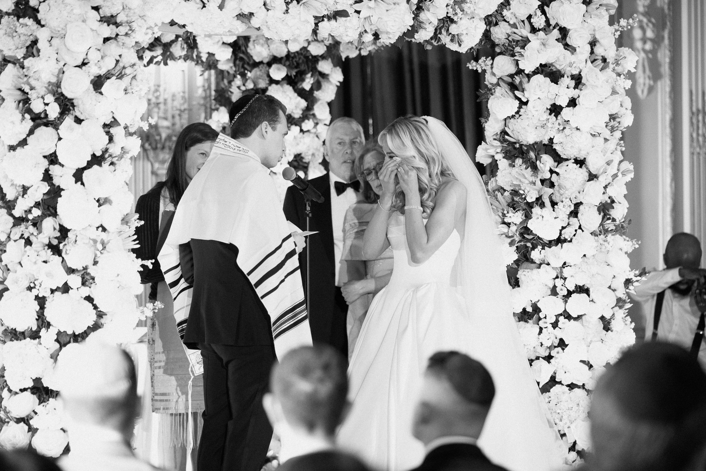 Black-and-white ceremony moment beneath the chuppah