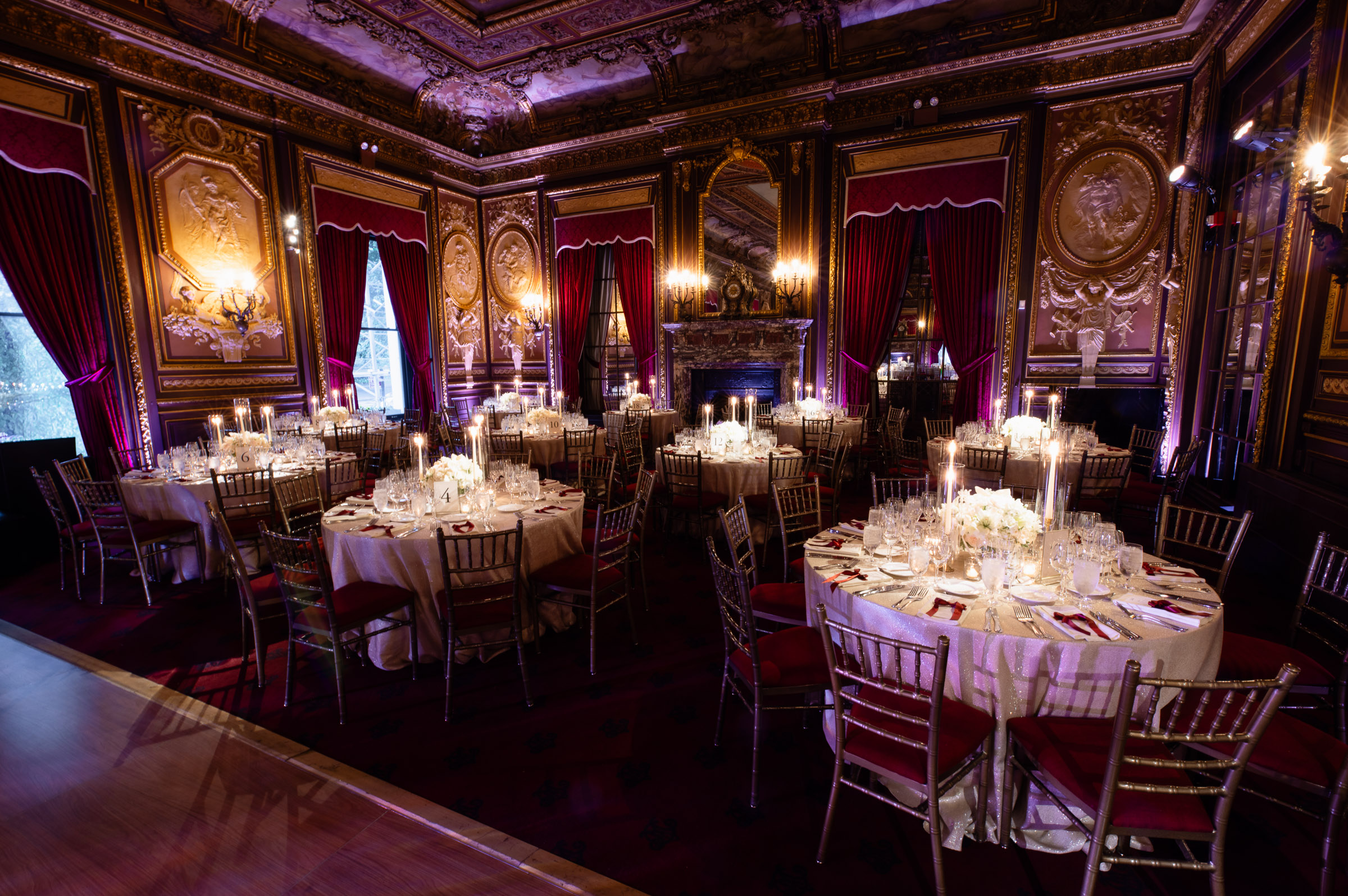Warmly lit Metropolitan Club reception room set for dinner