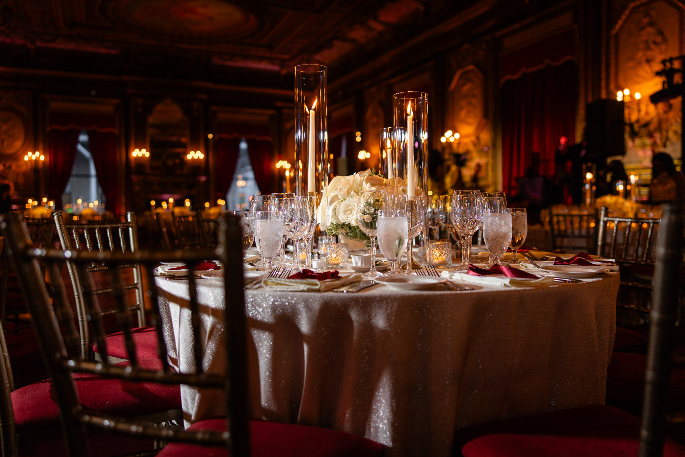 Candlelit wedding tables with white floral centerpieces