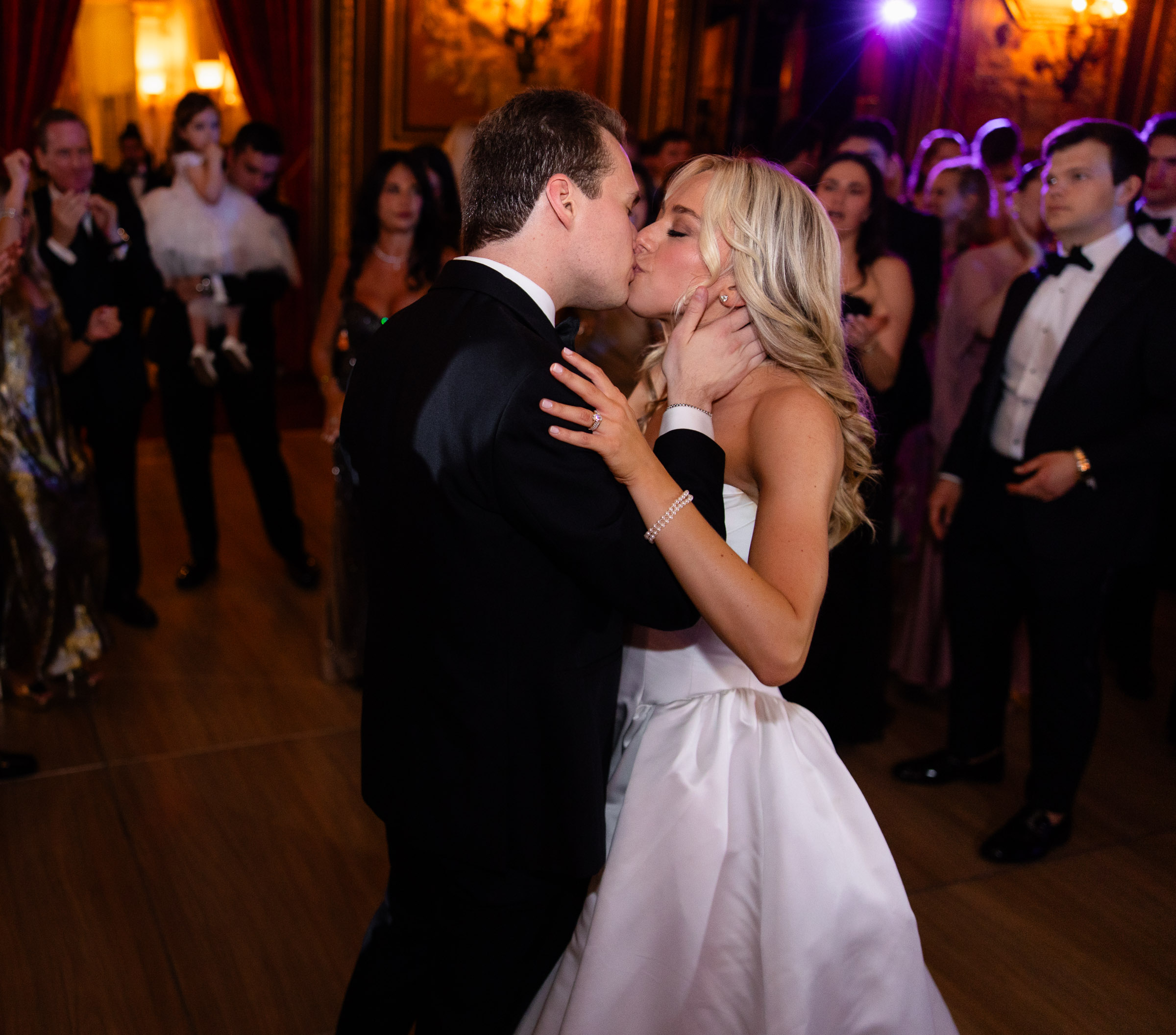 Colette and Cameron kissing on the reception dance floor