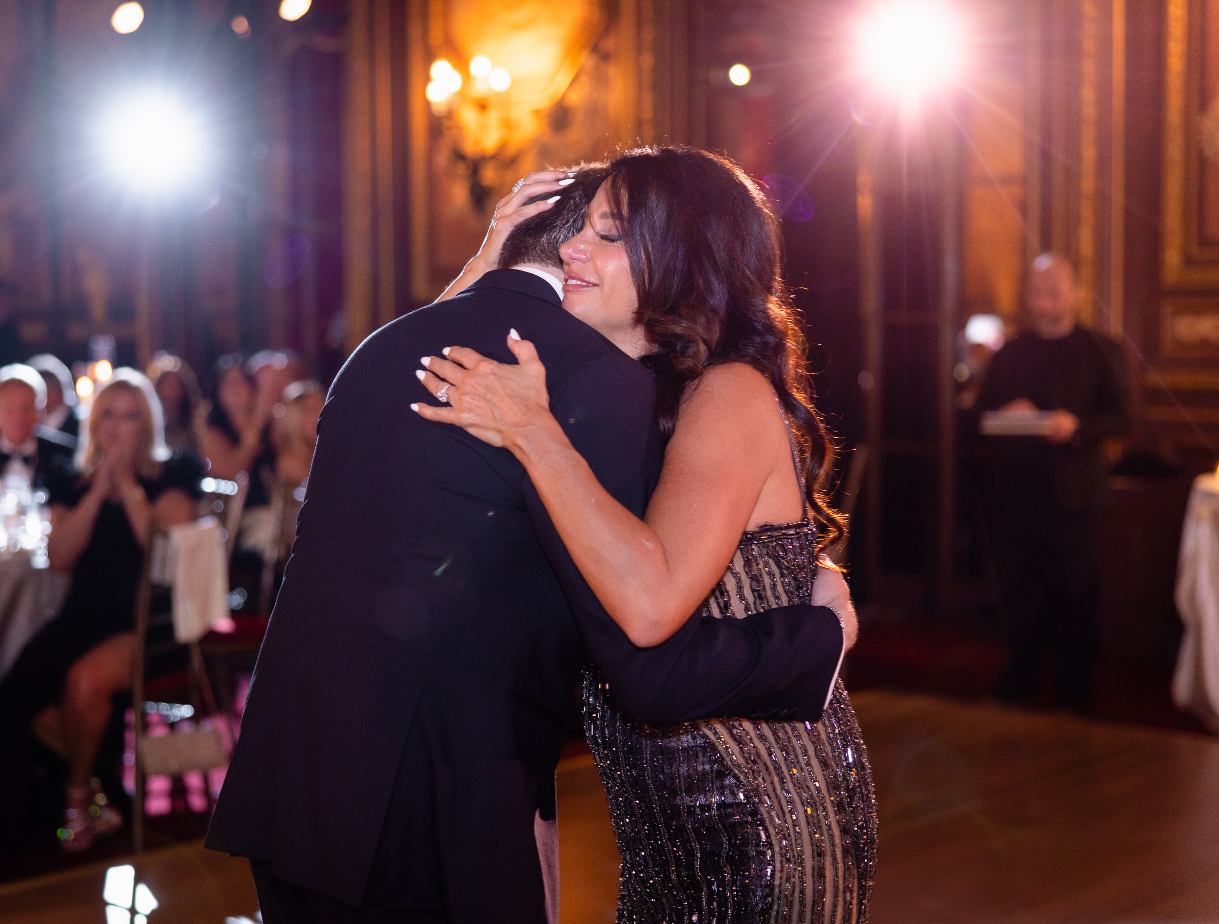 Colette embracing a family member during the reception