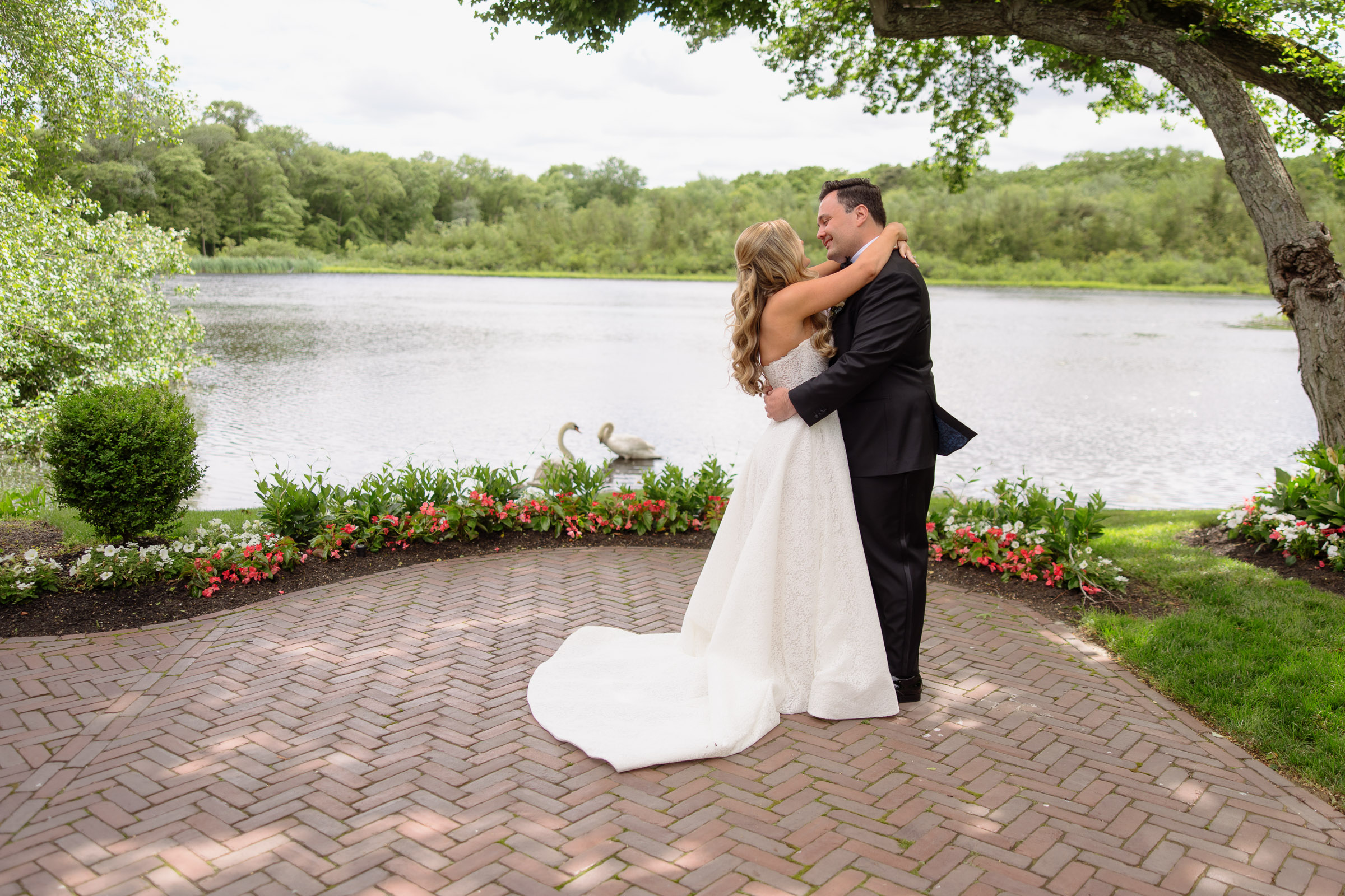 Liz and Austin embracing beside the lake after their first look