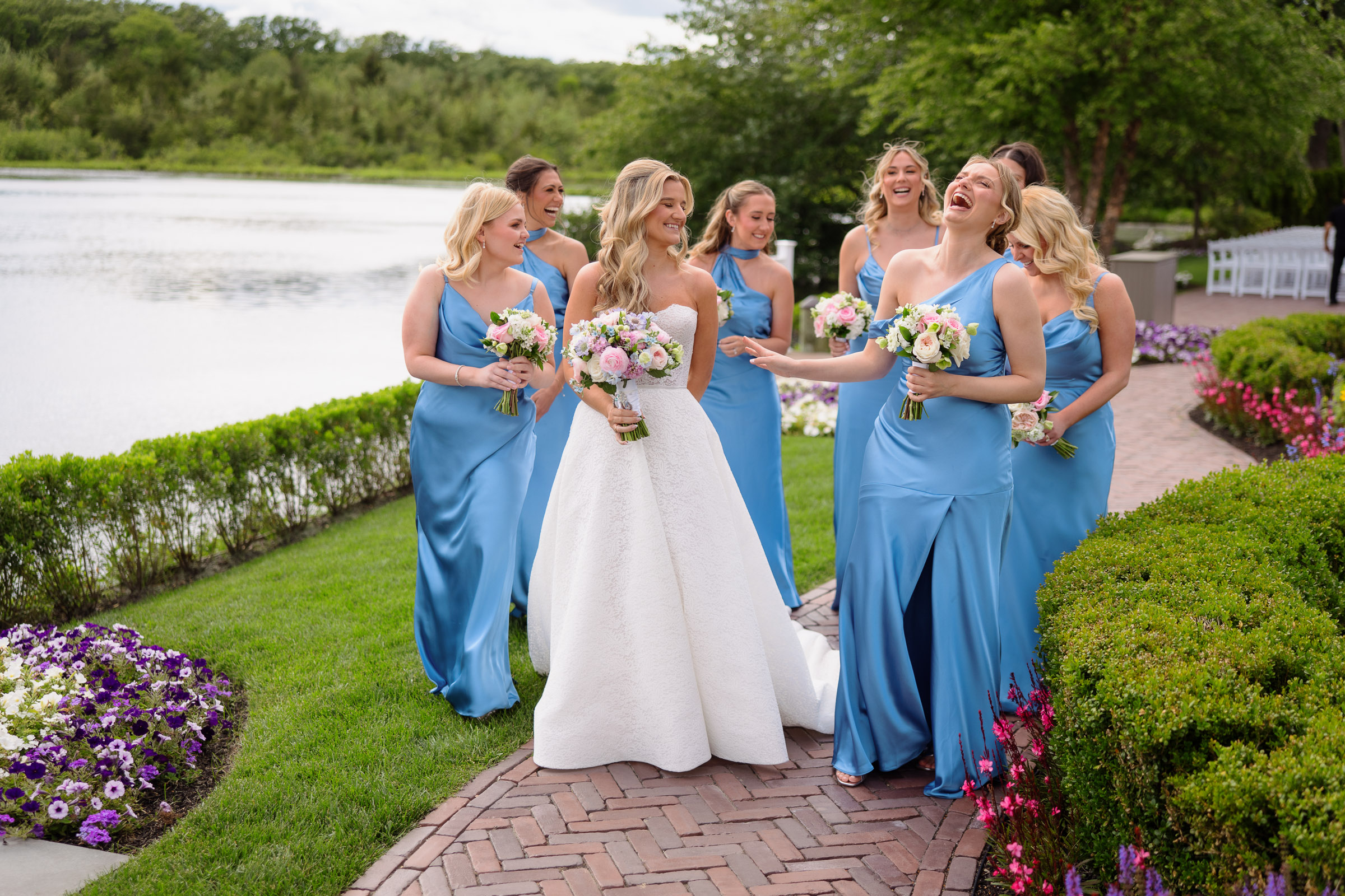 Liz with her bridesmaids in blue dresses beside the lake