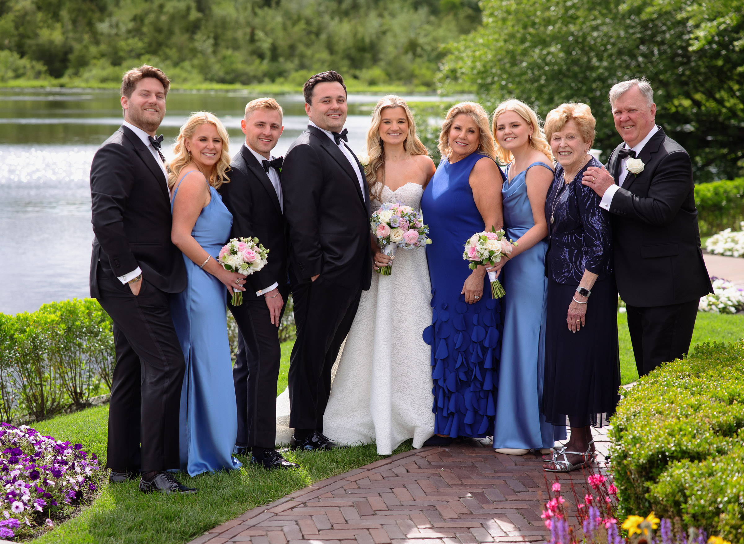 Liz and Austin posing with their families before the ceremony