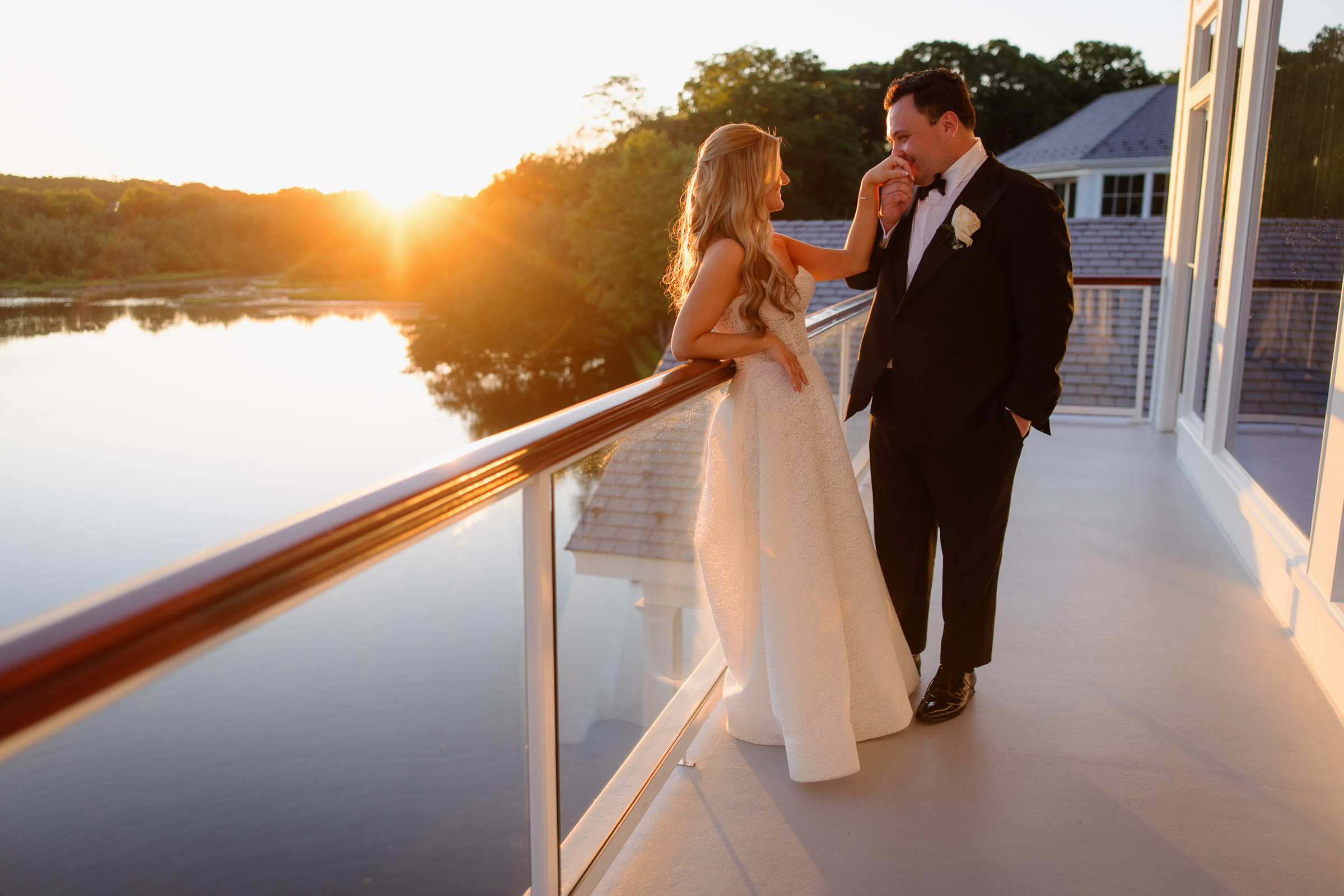 Wide sunset portrait of Liz and Austin overlooking the water