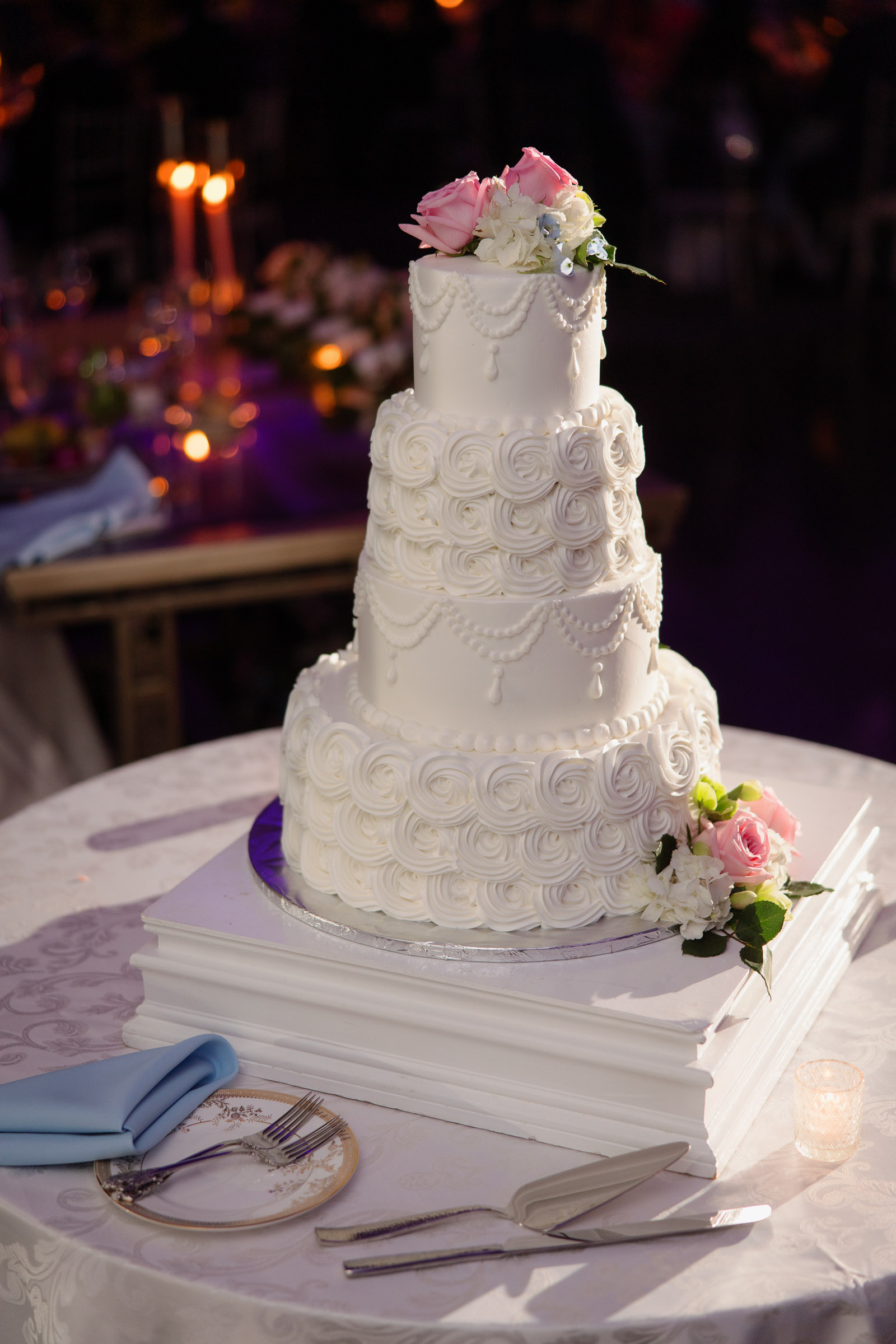 White wedding cake decorated with blush flowers