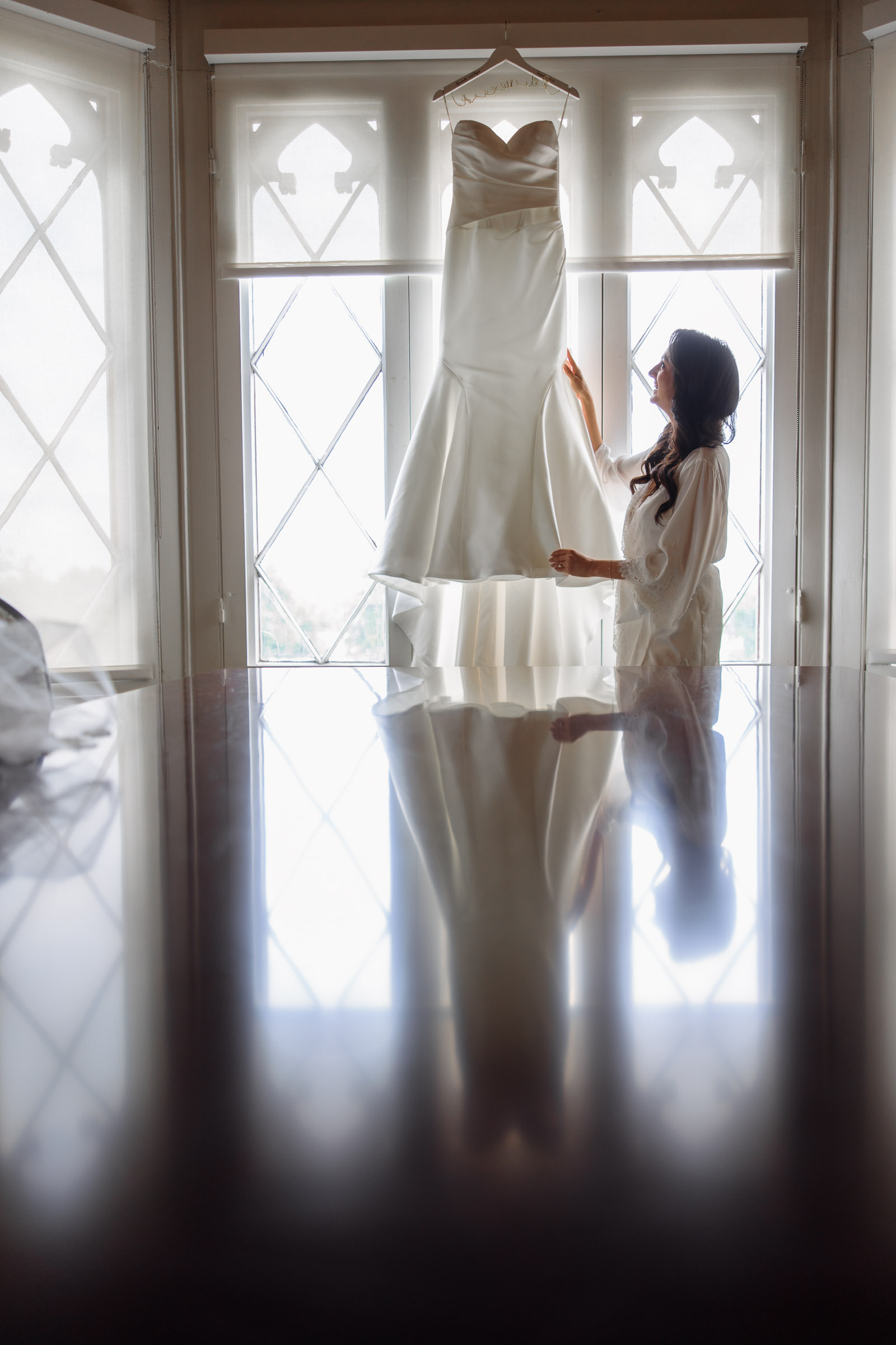 Alexandra silhouetted at the castle windows before dressing
