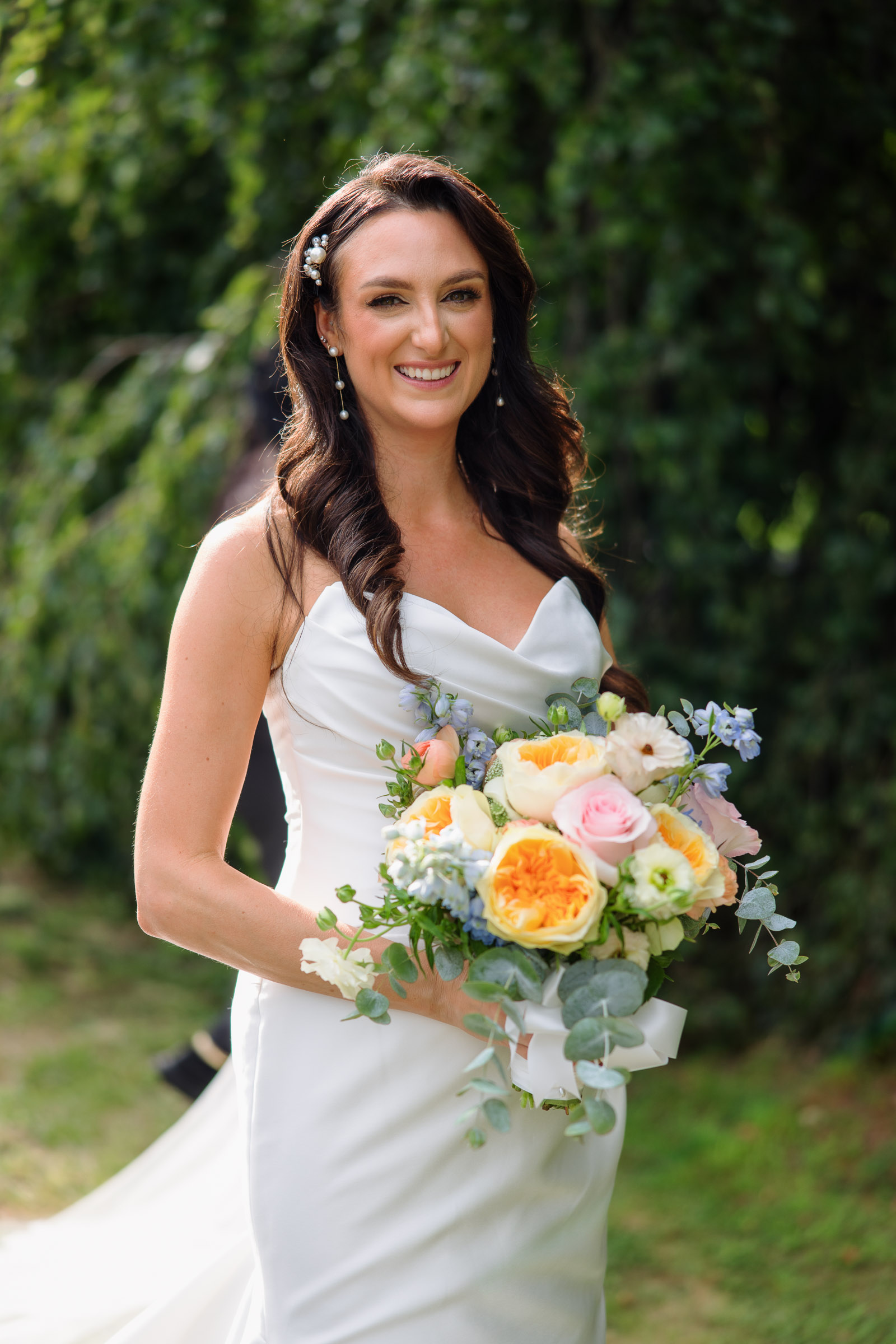 Alexandra holding her pastel bouquet outdoors at Whitby Castle