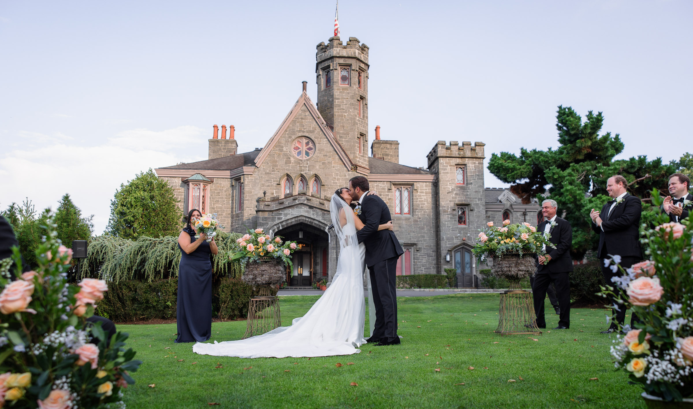 Wide Whitby Castle ceremony view with pastel floral arrangements