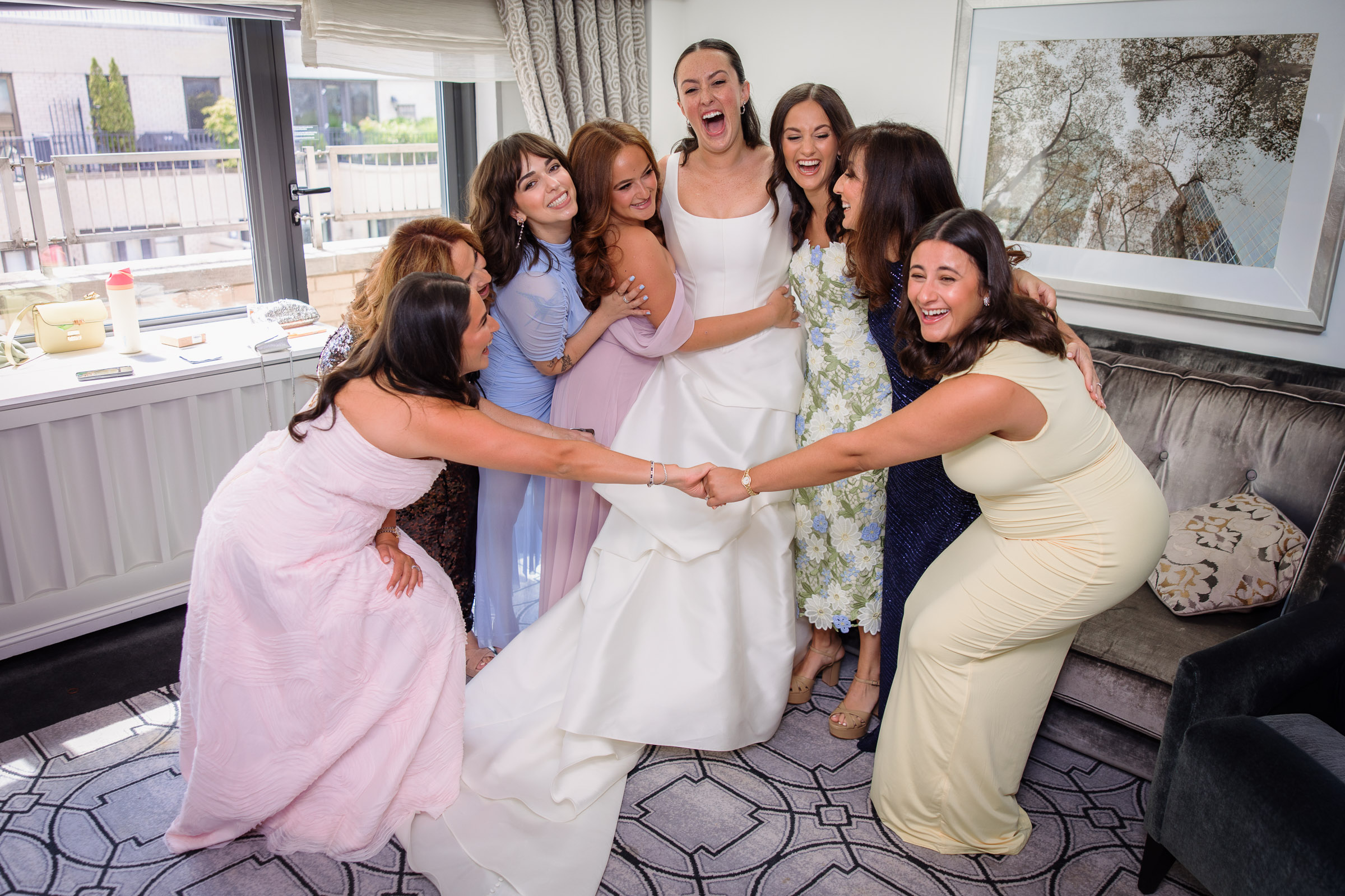 Sydney celebrating with friends in colorful dresses during morning preparations