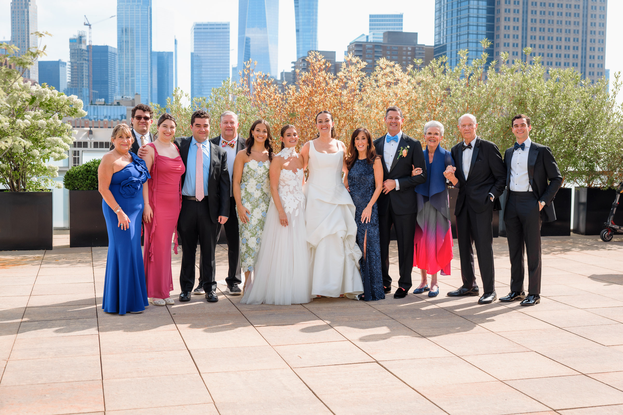 Sydney and Delilah surrounded by their families on the Tribeca Rooftop terrace