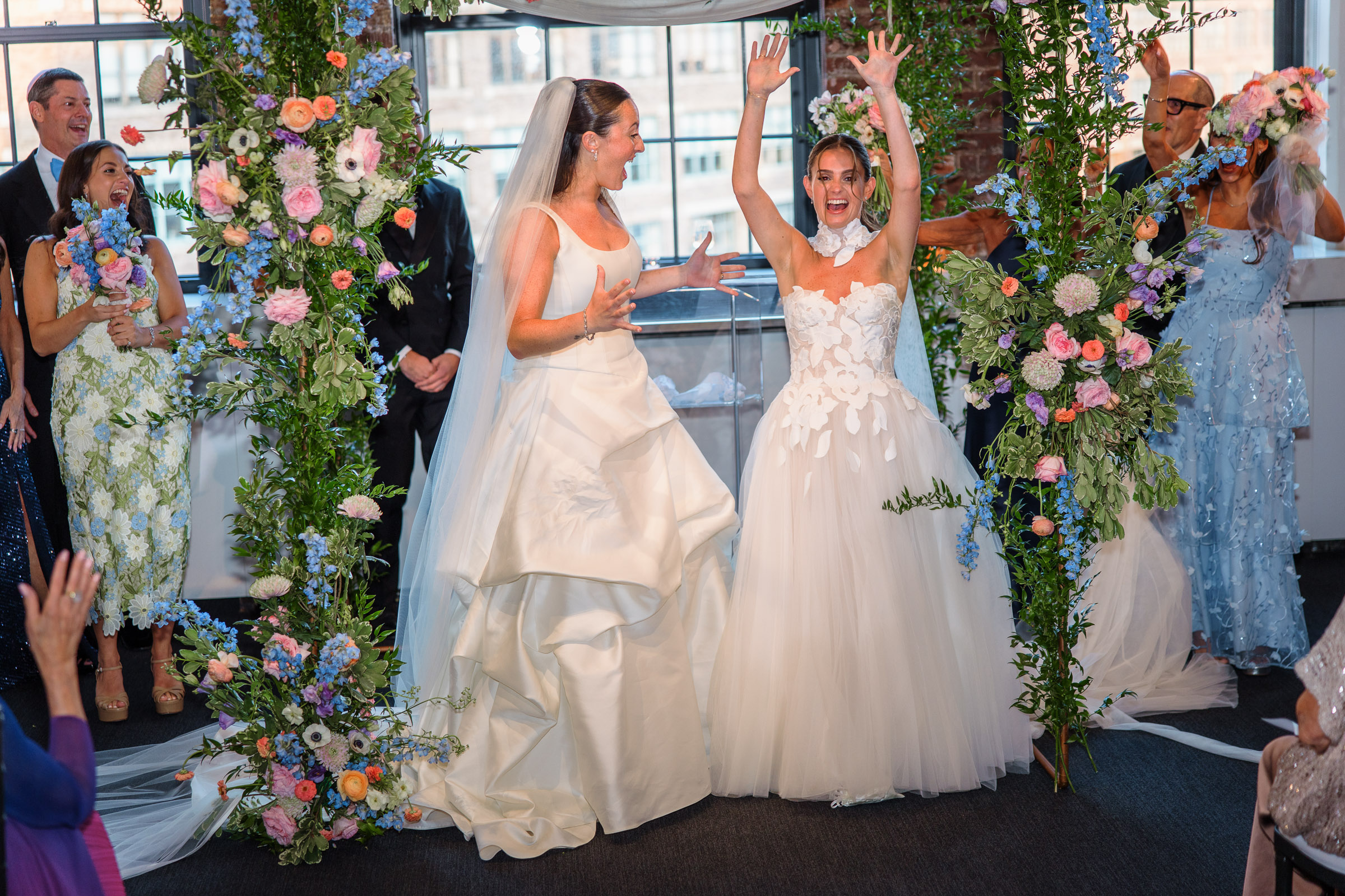 The newlyweds raising their joined hands at the end of the ceremony