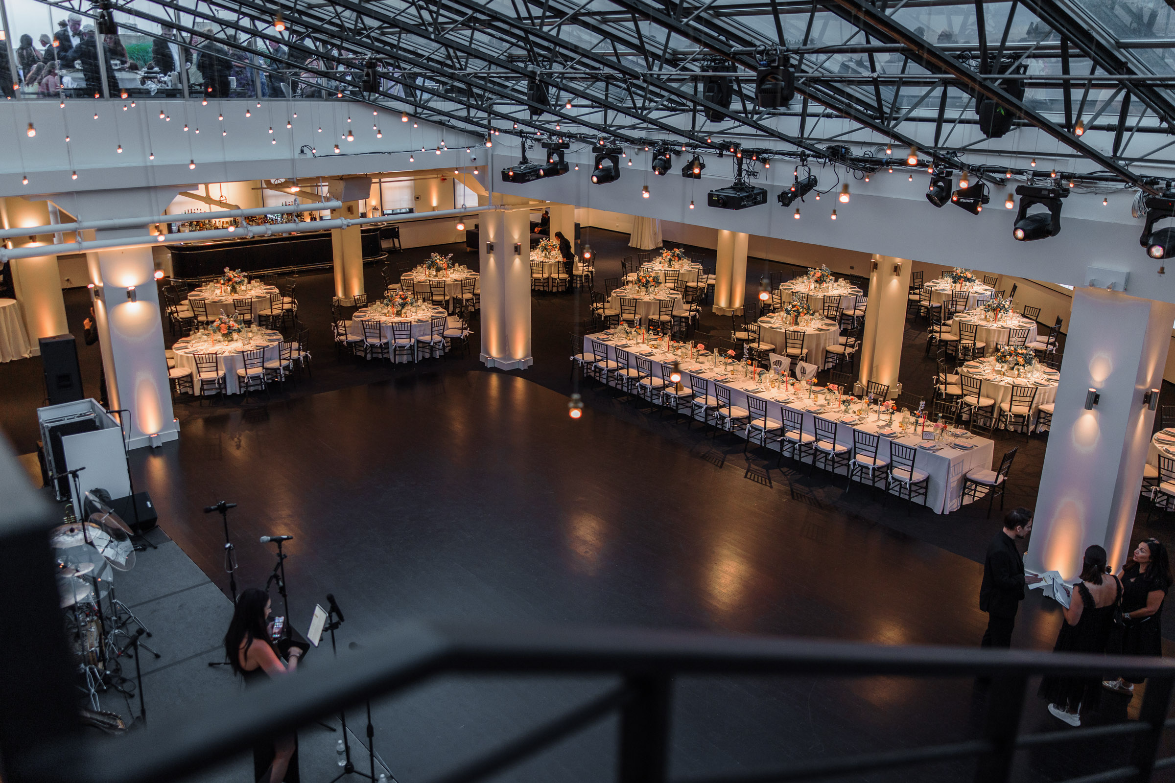 Wide view from the staircase of the candlelit Tribeca Rooftop reception room