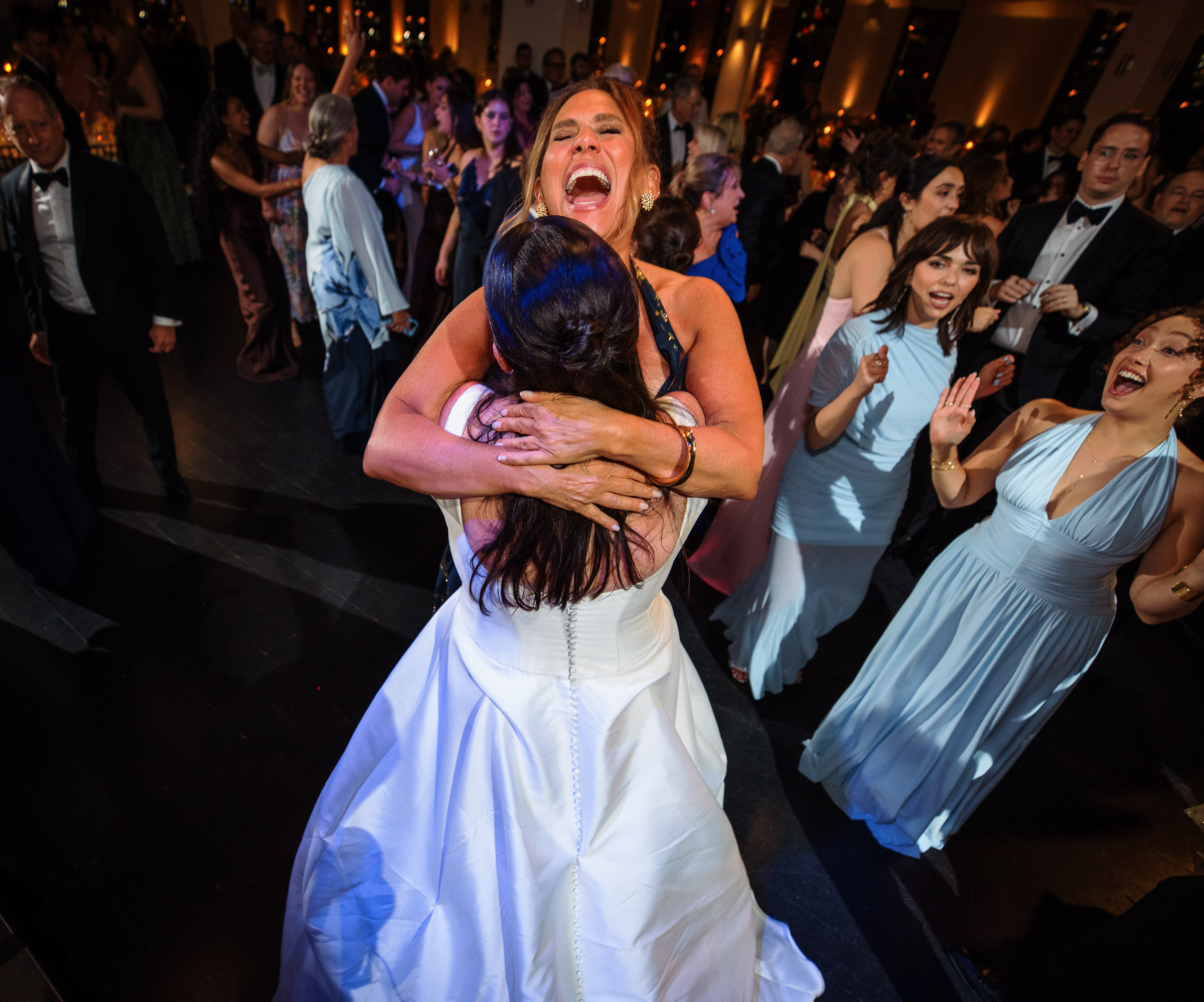 Emotional dance-floor moment as a bride celebrates with guests around her