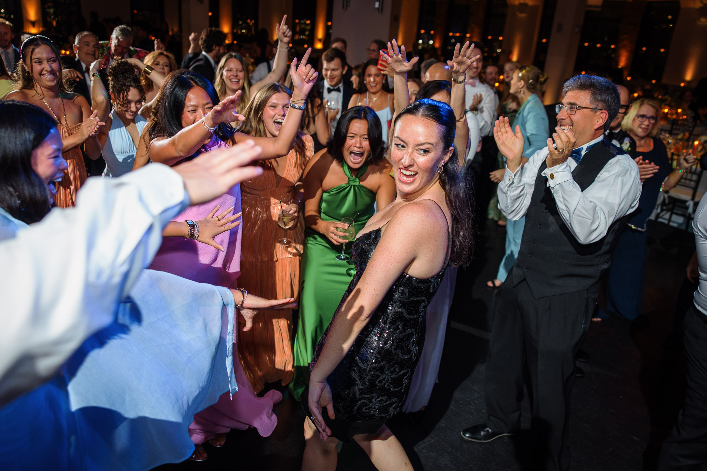 Sydney and Delilah embracing in the center of a lively hora dance